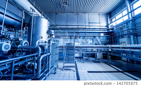 Modern interior of a beverage plant with barrels and pipes 142705875
