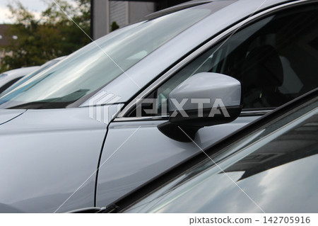 Different cars parked tightly next to each other near residential houses Different cars parked tightly next to each other near residential houses 142705916
