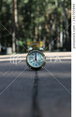 Defocused Park Paved Walk Path with Bell Clock on It in Early Morning. A Boost of Morning Energy at 8AM Defocused Park Paved Walk Path with Bell Clock on It in Early Morning. A Boost of Morning Energy at 8AM 142705949