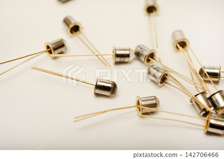 Metal photodiodes on a white background. Phototransistors. Yellow semiconductor devices. Metal photodiodes on a white background. Phototransistors. Yellow semiconductor devices. 142706466