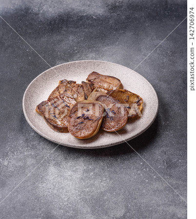 Slices of grilled pork or beef tongue seasoned with salt and allspice. Sliced beef tongue 142706974