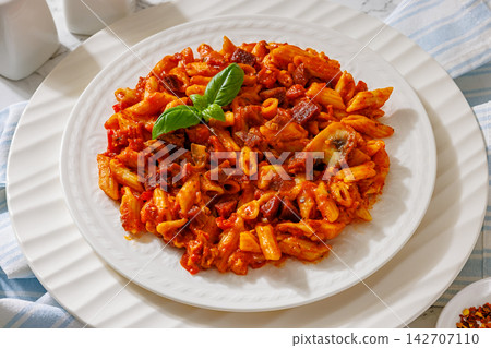 Penne rigate with smoked sausage cubes, sauce Penne rigate with smoked sausage cubes, sauce 142707110