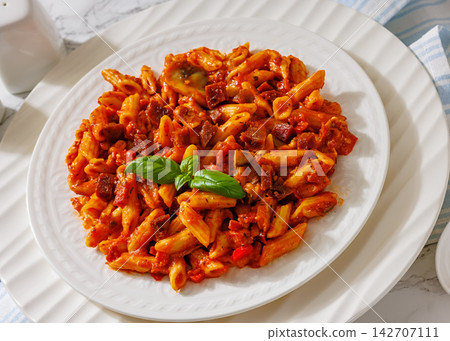 Italian penne dish with diced sausage, mushrooms Italian penne dish with diced sausage, mushrooms 142707111