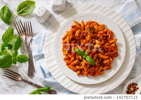 Penne alla salsiccia e funghi on a plate 142707115
