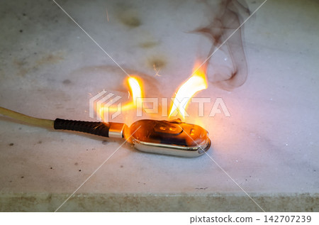 Smartwatch ignites with sparks and flames when connected to power cable Smartwatch ignites with sparks and flames when connected to power cable 142707239