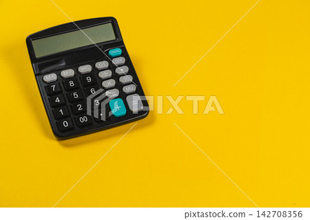Calculator for business calculations on a yellow background Calculator for business calculations on a yellow background 142708356