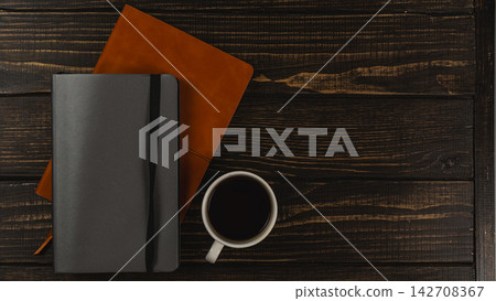 Coffee cup on a desk with notebooks and a calm workspace setup Coffee cup on a desk with notebooks and a calm workspace setup 142708367