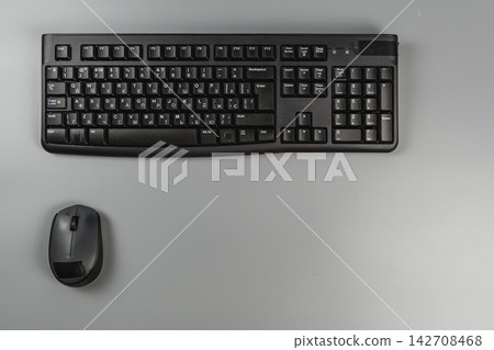 Modern keyboard and mouse on a gray desk in a business workspace Modern keyboard and mouse on a gray desk in a business workspace 142708468
