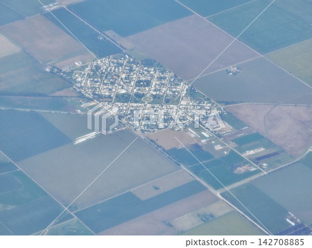 Small Rural Town Surrounded by Farmland Seen from Airplane Small Rural Town Surrounded by Farmland Seen from Airplane 142708885