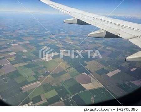 Airplane Wing Over Colorful Fields and Circular Farmland in Argentina Airplane Wing Over Colorful Fields and Circular Farmland in Argentina 142708886