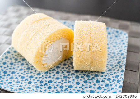 The appeal of a roll cake's cross-section: fluffy sponge cake and cream. The appeal of a roll cake's cross-section: fluffy sponge cake and cream. 142708990
