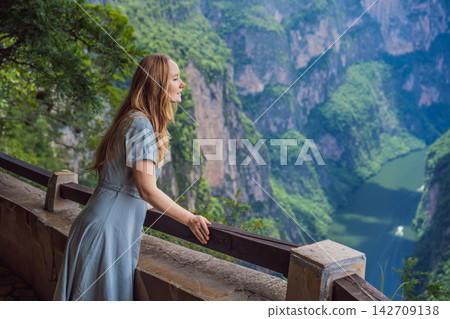 Woman tourist admiring the dramatic Sumidero Canyon viewpoint in Chiapas Mexico with steep canyon walls lush landscape river overlook nature tourism and enjoying a scenic overlook. Woman tourist admiring the dramatic Sumidero Canyon viewpoint in Chiapas Mexico with steep canyon walls lush landscape river overlook nature tourism and enjoying a scenic overlook. 142709138