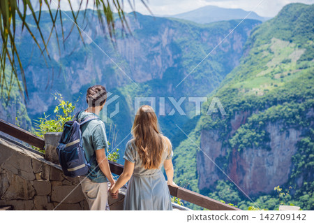 Couple travelers standing together at Sumidero Canyon viewpoint in Chiapas Mexico with steep canyon walls lush landscape river overlook nature tourism and admiring the river landscape. 142709142