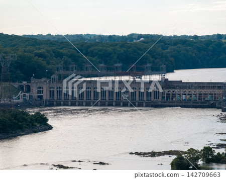 Aerial view of a large hydroelectric power plant on a wide river 142709663