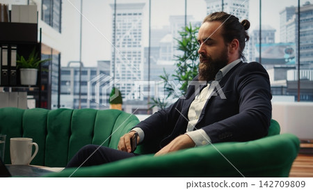 Business administrator struggling to negotiate over the phone, receiving a negative answer and being dissatisfied with himself. Displeased boss dealing with bad news and disappointment. Camera B. Business administrator struggling to negotiate over the phone, receiving a negative answer and being dissatisfied with himself. Displeased boss dealing with bad news and disappointment. Camera B. 142709809