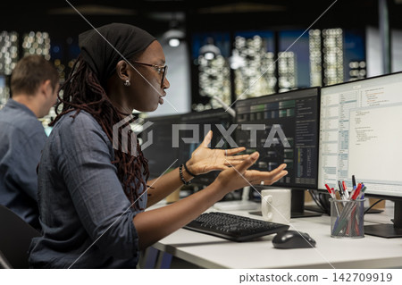 Cranky startup office engineer surprised by malfunctioning machine learning models enhancing automation. Irritated woman in Silicon Valley workplace ranting about with broken AI assistant on computer Cranky startup office engineer surprised by malfunctioning machine learning models enhancing automation. Irritated woman in Silicon Valley workplace ranting about with broken AI assistant on computer 142709919
