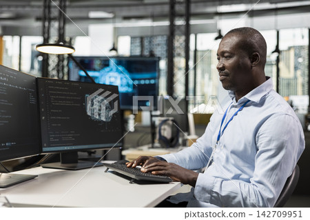 System administrator in office automating repetitive tasks using AI scripts on PC. IT specialist uses artificial intelligence tech on computer to speed up feature implementation 142709951