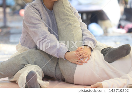 Woman doing bodywork Woman doing bodywork 142710202