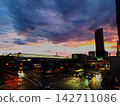 The area in front of the station after the rain and the cityscape bathed in the sunset. 142711086