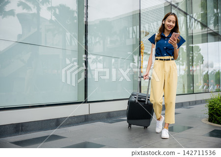 A stylish young woman stays productive on her business trip A stylish young woman stays productive on her business trip 142711536