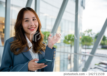 Woman with phone in office Woman with phone in office 142711539