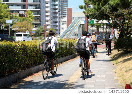 High school students commuting to school by bicycle High school students commuting to school by bicycle 142711900