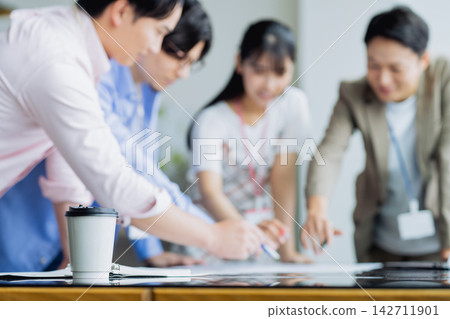 Young engineers in a meeting Young engineers in a meeting 142711901
