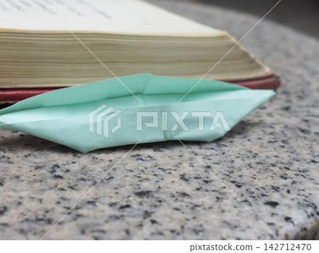 A paper boat that sets off on a journey through stories 142712470
