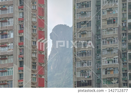Hong Kong Aug 29 2026 Lion Rock framed between Hong Kong residential buildings 142712877