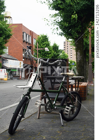 A stylish bicycle parked on the sidewalk A stylish bicycle parked on the sidewalk 142713206