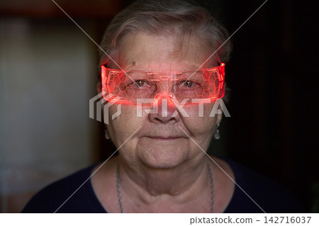 Senior Woman Wearing Red Light Glasses - Portrait Senior Woman Wearing Red Light Glasses - Portrait 142716037