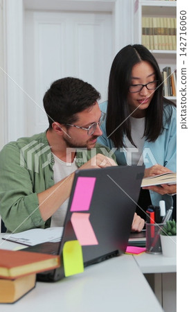 Happy multi ethnic college students smiling look at camera, posing in modern university library. Education, study, modern tech concept. Happy multi ethnic college students smiling look at camera, posing in modern university library. Education, study, modern tech concept. 142716060