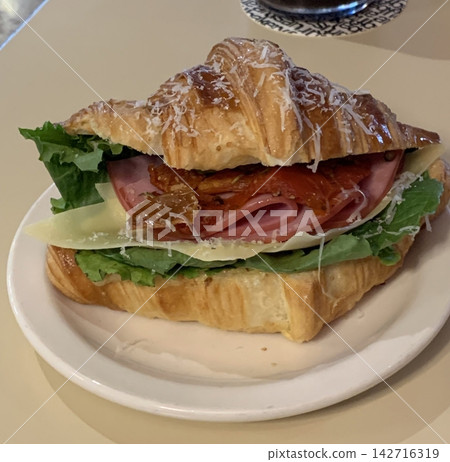 Flaky croissant sandwiches filled with fresh vegetables, deli meats, and creamy cheeses. A perfect balance of buttery layers and savory fillings for a satisfying meal or snack! Flaky croissant sandwiches filled with fresh vegetables, deli meats, and creamy cheeses. A perfect balance of buttery layers and savory fillings for a satisfying meal or snack! 142716319