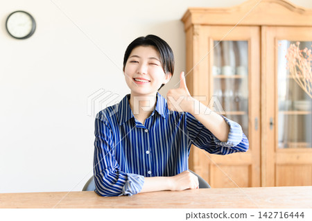 一位女士高興地豎起大拇指 一位女士高興地豎起大拇指 142716444