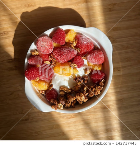 Creamy yogurt bowl topped with fresh fruits and crunchy toppings, offering a smooth texture and refreshing taste. Light, wholesome, and visually appealing, perfect for breakfast or healthy snack. Creamy yogurt bowl topped with fresh fruits and crunchy toppings, offering a smooth texture and refreshing taste. Light, wholesome, and visually appealing, perfect for breakfast or healthy snack. 142717443
