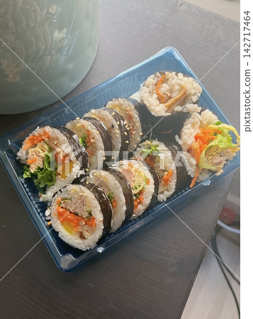Fresh kimbap rolls filled with rice, vegetables, and savory ingredients, neatly wrapped in seaweed. Colorful, balanced, and satisfying, offering a classic Korean flavor with a clean, appetizing look. Fresh kimbap rolls filled with rice, vegetables, and savory ingredients, neatly wrapped in seaweed. Colorful, balanced, and satisfying, offering a classic Korean flavor with a clean, appetizing look. 142717464