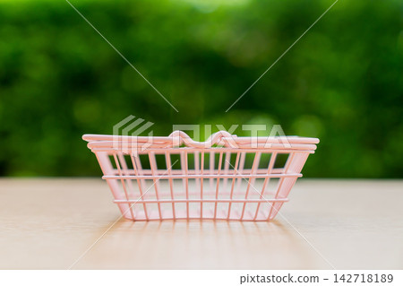 small basket on green grass small basket on green grass 142718189