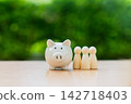 Piggy bank on table with green nature background, Save money for prepare retirement concept. 142718403