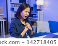 Young Asian businesswoman experiencing chest pain while working in an office. 142718405