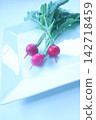 Beautiful radishes served on a square white plate. 142718459