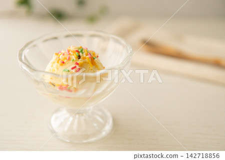 柔和的光線籠罩著透明的玻璃容器,營造出一張桌面甜點照片,突顯了柔和色調的配料。 柔和的光線籠罩著透明的玻璃容器,營造出一張桌面甜點照片,突顯了柔和色調的配料。 142718856