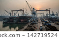 A construction site with huge cranes 142719524