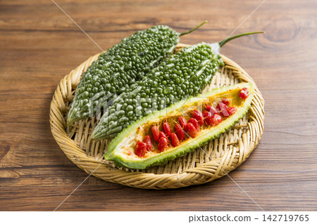 Bitter gourd and red seeds 142719765