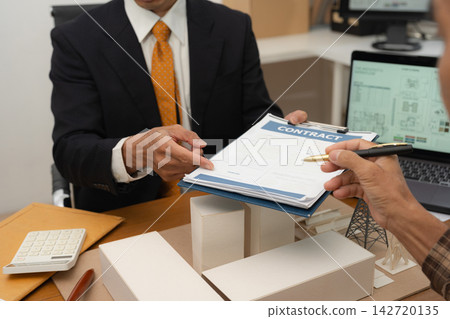 Concept of construction law, real estate development, renewable energy housing, and engineering collaboration. Concept of construction law, real estate development, renewable energy housing, and engineering collaboration. 142720135