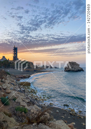 Golden sunrise light illuminates Penon del Cuervo Beach creating a peaceful Mediterranean seascape with gentle waves and rugged coastal scenery in Malaga, Spain Golden sunrise light illuminates Penon del Cuervo Beach creating a peaceful Mediterranean seascape with gentle waves and rugged coastal scenery in Malaga, Spain 142720469