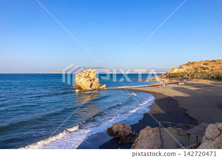 Golden sunrise light illuminates Penon del Cuervo Beach creating a peaceful Mediterranean seascape with gentle waves and rugged coastal scenery in Malaga, Spain Golden sunrise light illuminates Penon del Cuervo Beach creating a peaceful Mediterranean seascape with gentle waves and rugged coastal scenery in Malaga, Spain 142720471