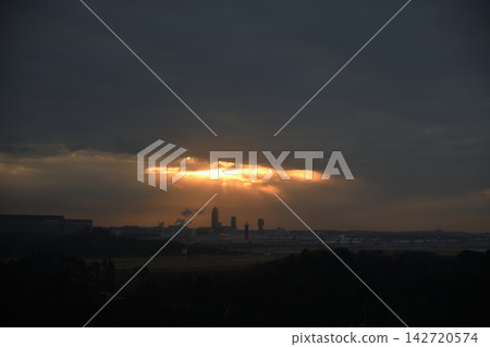 The control tower of Narita Airport is illuminated by the rising sun shining through a gap in the clouds. The control tower of Narita Airport is illuminated by the rising sun shining through a gap in the clouds. 142720574