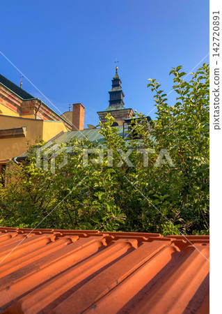 Cathedral of St. John the Baptist rising above historic rooftops and surrounding urban landscape in Przemysl, Poland Cathedral of St. John the Baptist rising above historic rooftops and surrounding urban landscape in Przemysl, Poland 142720891