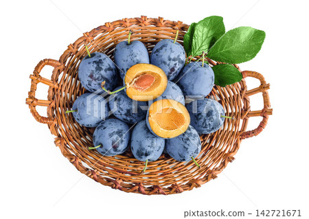 fresh blue plum in wicker basket isolated on white background. Top view. Flat lay fresh blue plum in wicker basket isolated on white background. Top view. Flat lay 142721671