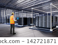 Programmer or engineer with computer notebook in data center 142721871